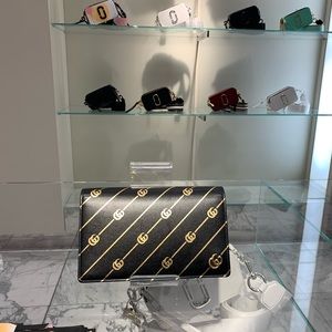 Black and gold GUCCI wallet/clutch on chain.